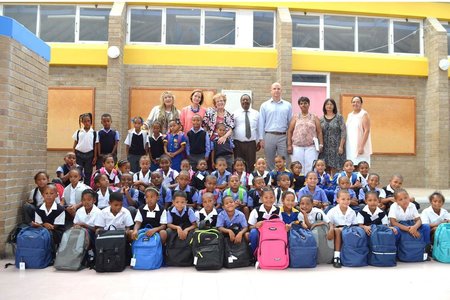 Captured with the three grade-one classes at Mount Pleasant Primary, the recipients of a stationery-filled backpack are: Back row - Lianda Beyers-Cronjé (Ward 4 Councillor), Ann Wright (Manager: Sustainable Futures Trust), Executive Mayor Nicolette Botha-Guthrie (Overstrand Municipality), Mattie Hull (Principal: Mount Pleasant Primary School), Michael Cardo (MP: Shadow Minister of Economic Development) and Deborah Wehr, Helen Steneveld and Edith Appollis (Grade One Teachers: Mount Pleasant Primary School).